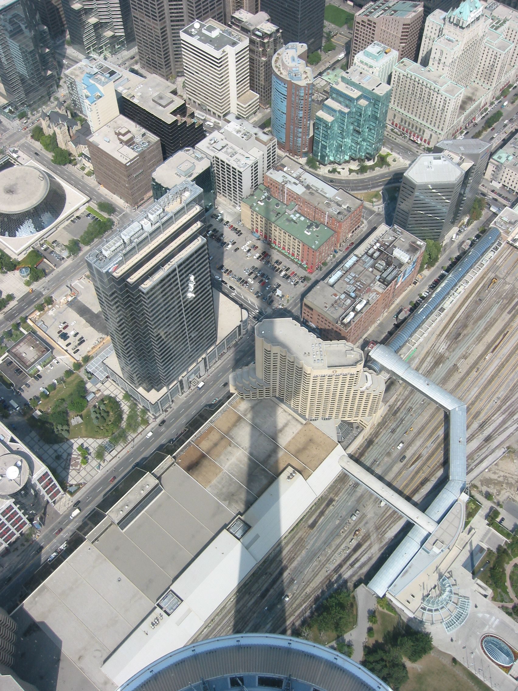The tower&rsquo;s own shadow reaching across downtown on a late-summer afternoon &mdash; the light is more generous than most people expect.